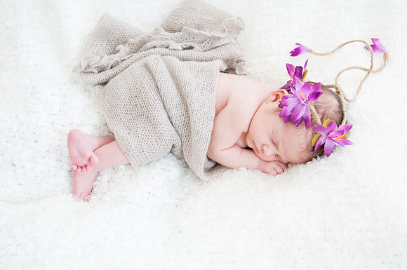 sleeping baby with a purple flower headband