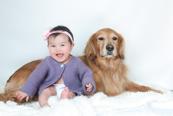 Cute baby and golden retriever, natural light